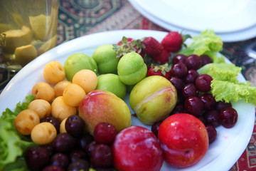 Naklejka na ściany i meble Summer fruits in plate on the table