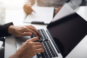 Managers are using fingers to typing personal information of employees who apply for jobs on the computer.