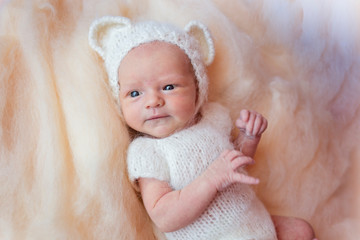 Fototapeta na wymiar Portrait of a newborn baby with open eyes in a polar bear costume