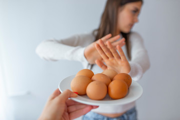 Woman refusing to eat eggs. Egg Free Affected Allergy Banned Restriction. Young beautiful woman...