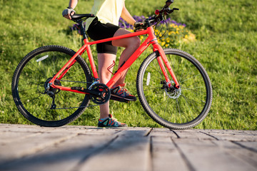 Young woman with bike outdoors at the park