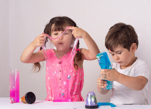 a-little-girl-hands-making-slime-herself-on-blue-wooden-background-slime- making-hand-children-toy_t20_rRaG0g - The Breakie Bunch Learning Center