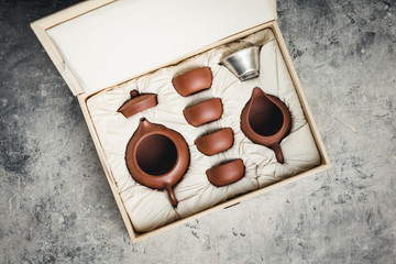 Tea set in the box on concrete background