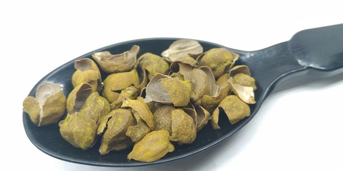 A picture of chickpeas rinds on black spoon