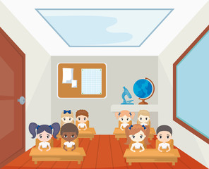 group of little students seated in school desks in classroom