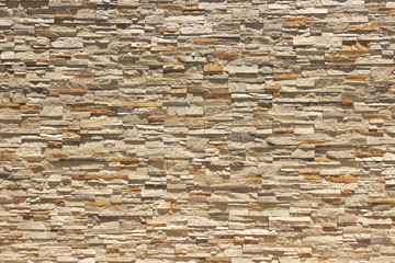 Brick wall of decorative slate stone, colorful horizontal architecture.
