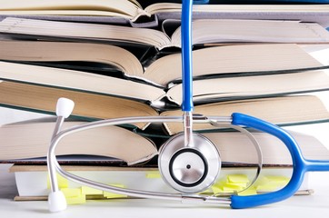 Open medical books, stethascope. Process of medical learning
