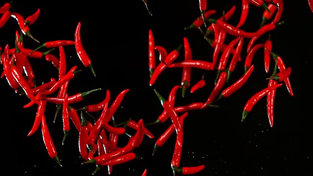 Super Slow Motion Shot of Flying Red Chilli Peppers at 1000fps.