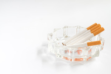 Cigarette and ashtray on white background