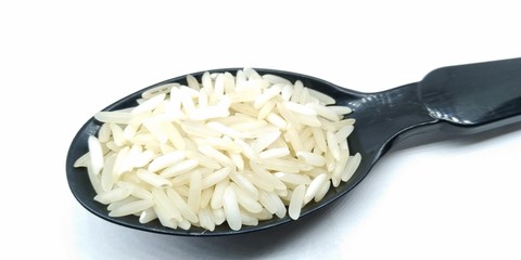A picture of rice on black spoon
