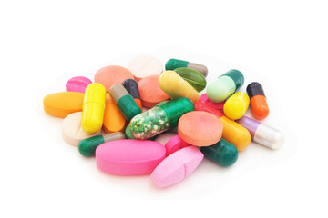 Medication and healthcare concept. Heap of colorful  pills and drugs isolated on white background