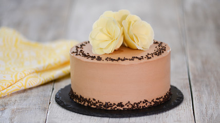 Delicious chocolate cake decorated with flowers on top.