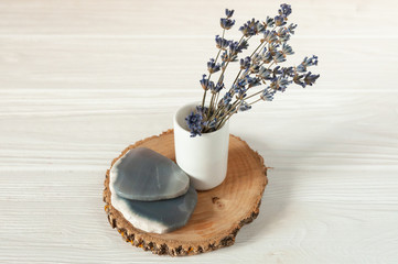 Obraz na płótnie Canvas lavender in a vase, on a wooden saw cut, boho rustic decor for home, white tree background