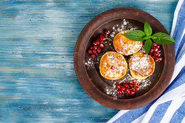Dairy products, cottage cheese pancakes with powdered sugar and berries