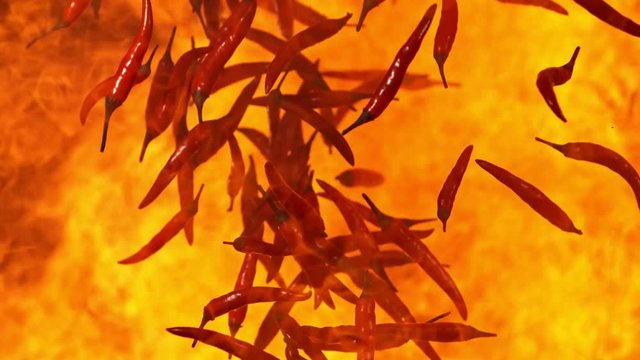 Super Slow Motion Shot of Falling Red Chilli Peppers to fire at 1000fps.