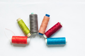 Fototapeta na wymiar Color sewing threads on white background,