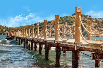 Fototapeta premium Scene at Tropical Beach Resort with wooden pier and rope