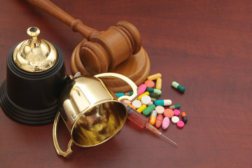 Doping in sport and court of arbitration concept. Judge gavel, broken golden champion cup and drugs.