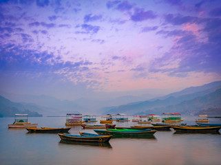 Amazing view of colorful row Boats in Phewa Lake after Sunset.