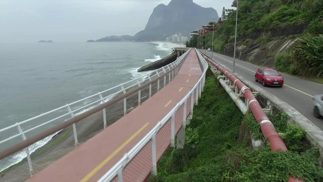 Highway by the sea. Wonderful road and bike path. Bicycle and road track and next to the blue sea in the city of Rio de Janeiro. Tim Maia bike path on Niemeyer Avenue, Rio de Janeiro, Brazil.