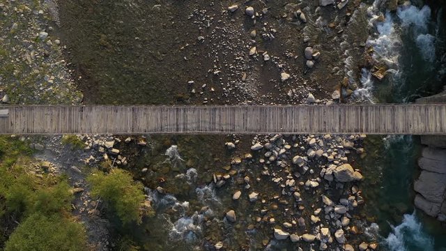 Aerial view of wooden bridge and mountain river round trip