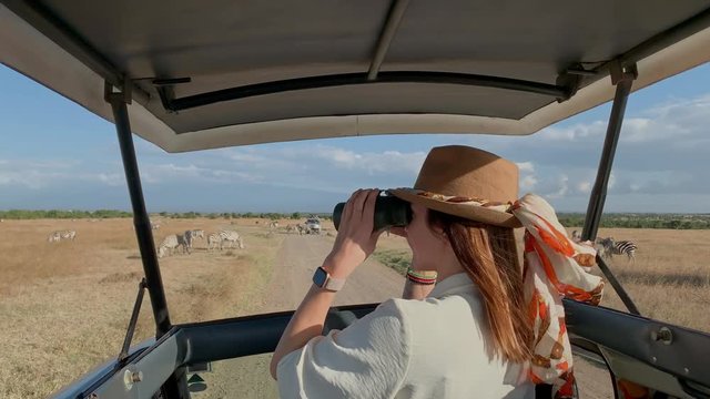 Woman on a safari trip in Masai Mara park, Kenya