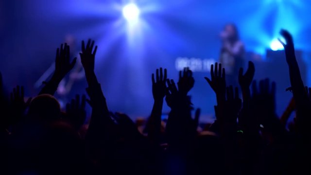 Crowd waving their hands and and enjoying great rock concert party. Slow motion, 4K