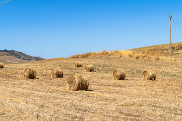 Fototapeta premium Sicilian Landscape with Hay Bales in the Field after the Harvest, Mazzarino, Caltanissetta, Sicily, Italy, Europe