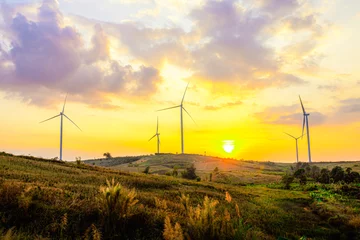  Night scene of landscape mountain view with windmills on the hill with sunset sky, Wind turbine generator to build electricity power in rural area, Electricity power concept © Nuttapon