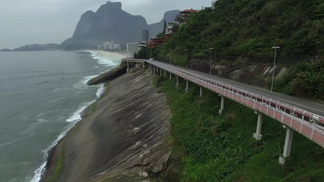 Highway by the sea. Wonderful road and bike path. Bicycle and road track and next to the blue sea in the city of Rio de Janeiro. Tim Maia bike path on Niemeyer Avenue, Rio de Janeiro, Brazil.