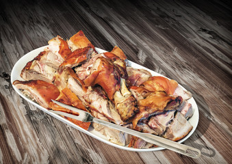 Plateful of Spit Roasted Pork Ham and Shoulder Slices Set on Old Cracked Flaky Wooden Garden Table