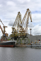 Fototapeta premium Industrial crane for unloading and loading in the river port
