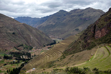 Inka ruins with Andens, stair-step like agricultural terrace dugs into the slope of a hillside in Pisac Archeological park, Peru