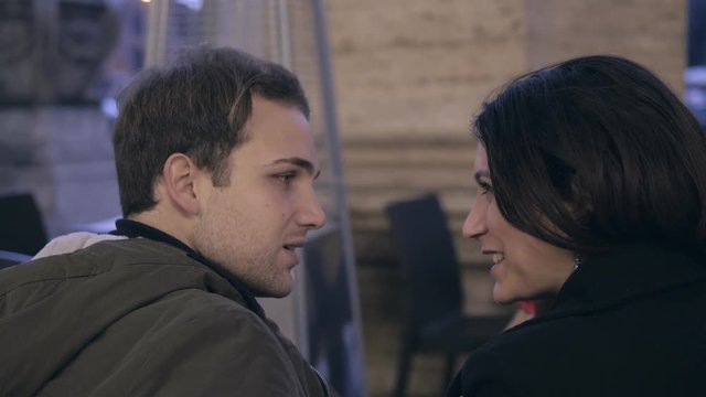 betrayer man kissing his girlfriend while flirting hide with other woman