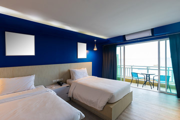 Dark blue tone interior of hotel room with sea view from window. interior room warm light style.