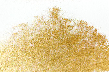 Golden glitter sparkle texture on white background.