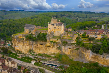 Fototapeta na wymiar Aerial landscape. Ancient medieval Castle of Beynac stands on a top of a hill over the Dordogne river. Beynac et Cazenac is a village labelled Most beautiful villages of France. 