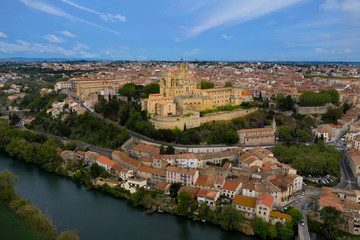 Fototapeta na wymiar Aerial view of Beziers city: Saint Nazaire Cathedral, river and bridges. A landscape from France.