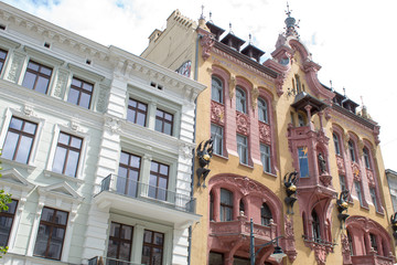  Fragments of beautiful restored ancient buildings of European cities against the blue sky on a summer sunny day.