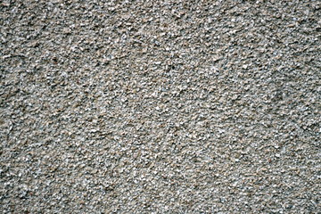 The texture of a stone wall of very small pebbles. Part of a stone wall, for background or texture.