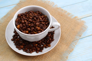 Fresh roasted coffee beans. Full cup of roasted coffee beans