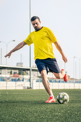 young man playing soccer on a grass field - 278050726