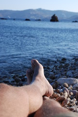 Feet at the beach at Patmos Island in Greece