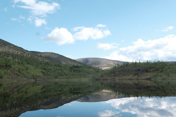 Naklejka na ściany i meble Lake surrounded by low mountains