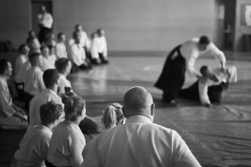 Aikido training. Black and white image. The teacher shows reception.  Traditional form of clothing...