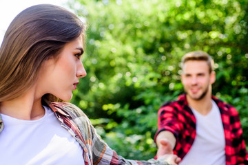 Fototapeta premium Sincere emotions. girl in selective focus with guy in park. couple in love. first meet of couple outdoor. Relationship. family weekend. romantic date. happy valentines day. summer camping in forest