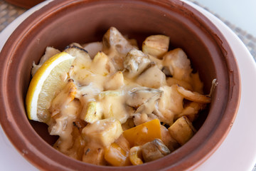 White fish baked with potatoes and a cheese