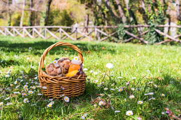 Lunch in the park on the green grass. Summer sunny day and picnic basket. Copy space.