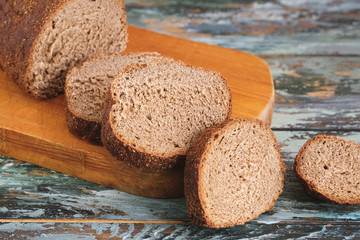 Sliced rye bread on a Board. On a wooden table.