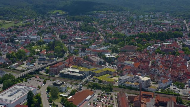 Aerial of the old part of town of Schorndorf in Germany. Very wide view with round pan to the left and tilt up across the whole town..